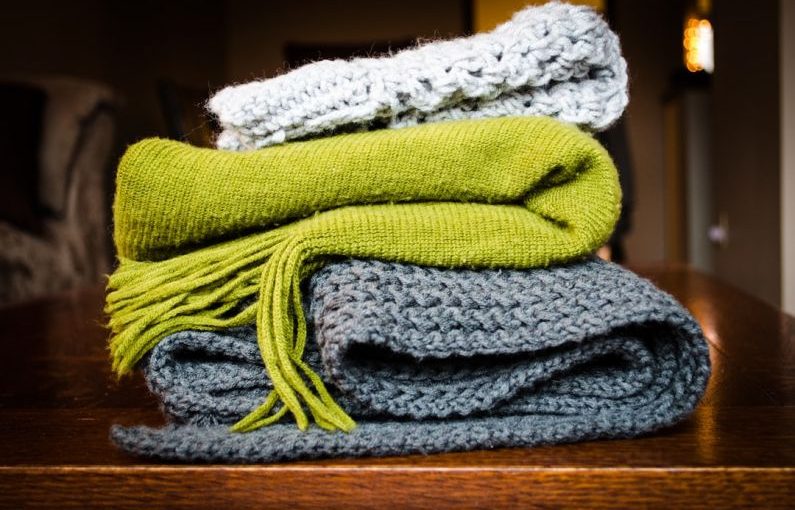 Scarves - three gray, green, and white scarf on top of table