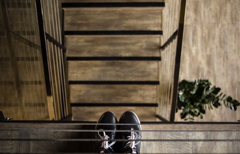 Footwear Industry - person standing near railing looking down